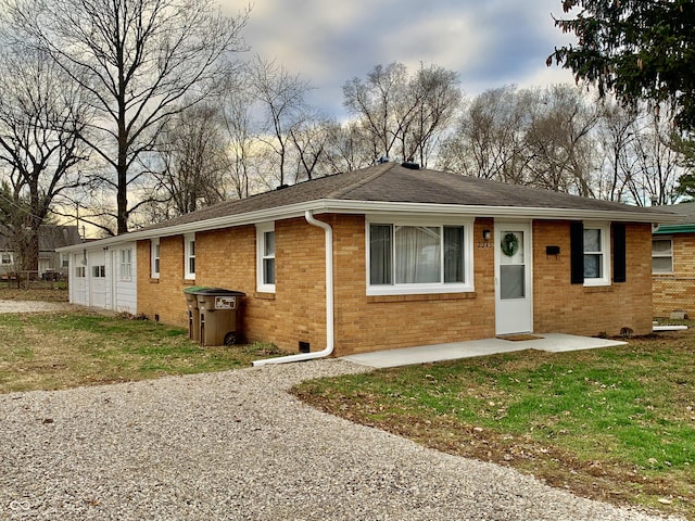 ranch-style home with a front lawn