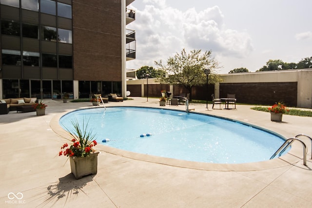 view of swimming pool with a patio