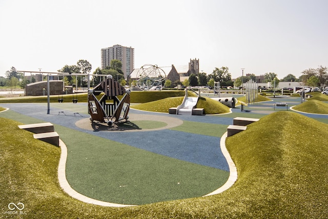 view of home's community with a lawn and a playground