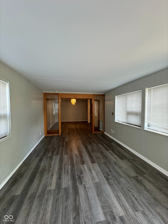 unfurnished living room with dark hardwood / wood-style flooring