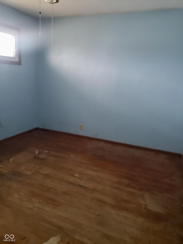 empty room with dark wood-type flooring