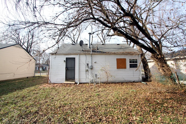 rear view of property with a yard