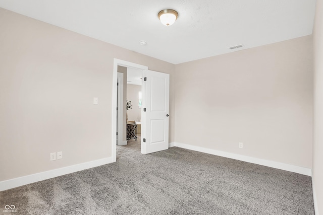 unfurnished room featuring carpet