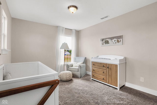 carpeted bedroom with a crib