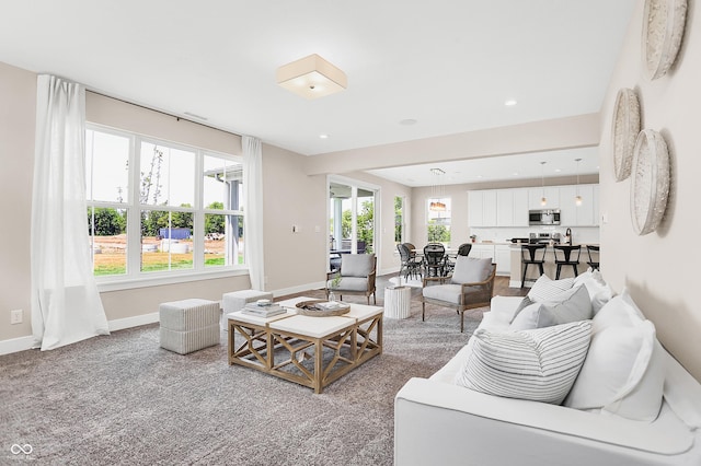 living room with a wealth of natural light and carpet floors