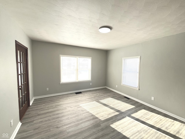 unfurnished room featuring dark hardwood / wood-style flooring