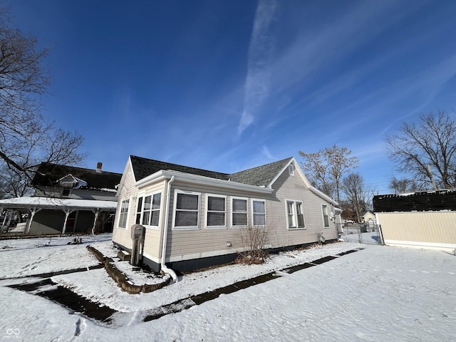 view of snow covered exterior with an outdoor structure