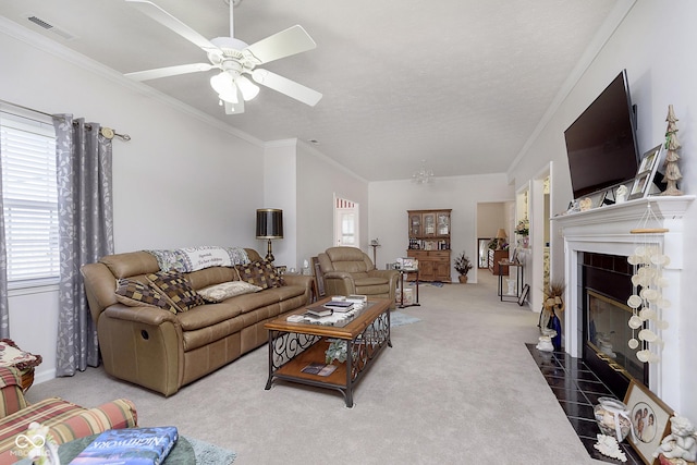 living room with ceiling fan, carpet floors, a textured ceiling, and ornamental molding