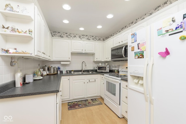 kitchen featuring white appliances, light hardwood / wood-style floors, white cabinetry, and sink