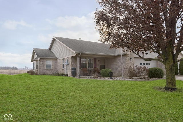 view of front of home with a front yard and a garage