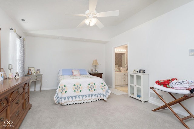 bedroom with connected bathroom, light colored carpet, ceiling fan, and lofted ceiling