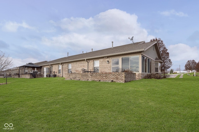 rear view of property featuring a lawn