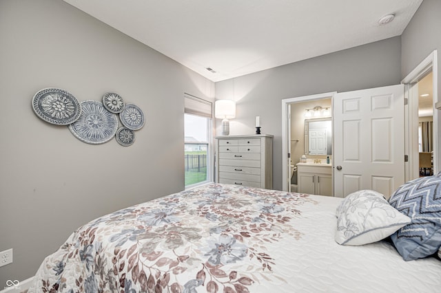 bedroom featuring connected bathroom and lofted ceiling