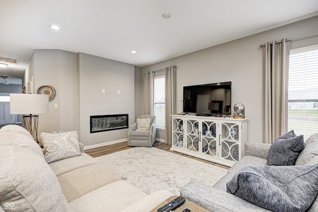 living room with hardwood / wood-style floors and a healthy amount of sunlight