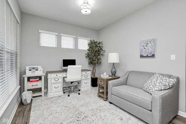 office with dark hardwood / wood-style floors and a textured ceiling