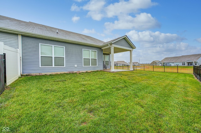 back of property with a lawn