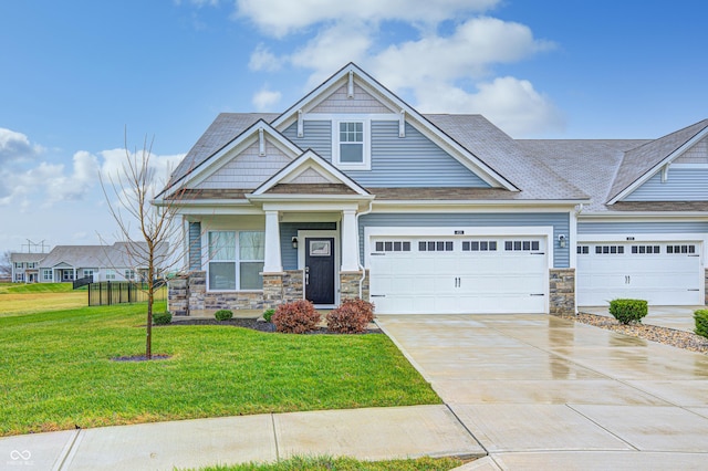 craftsman inspired home with a front yard and a garage