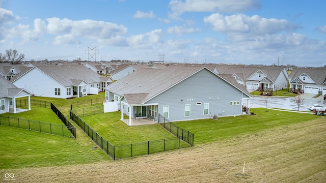 rear view of property featuring a yard