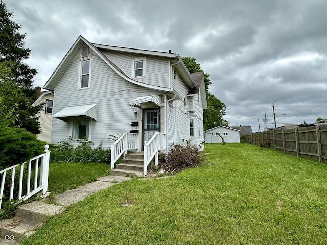 rear view of property with a lawn