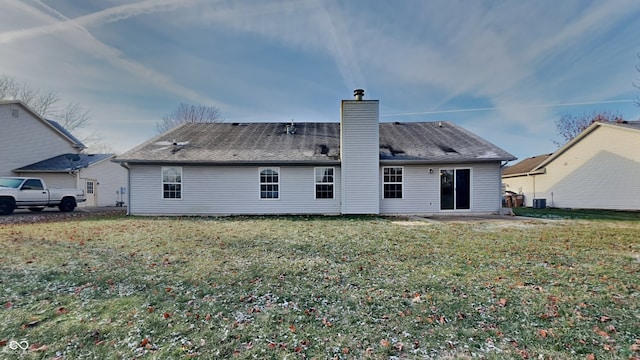 back of house featuring a lawn