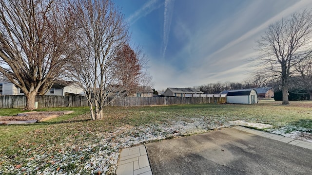 view of yard featuring a storage unit and a patio