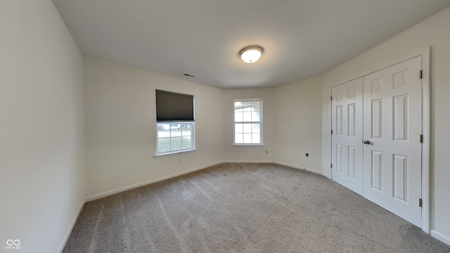 unfurnished bedroom with light carpet