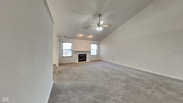 unfurnished living room featuring ceiling fan, light carpet, and high vaulted ceiling