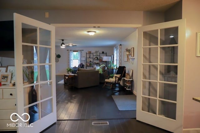 interior space with ceiling fan, dark hardwood / wood-style flooring, and french doors