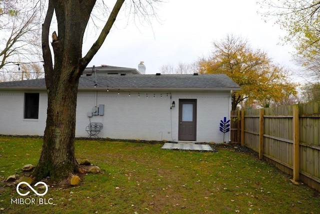 rear view of house with a yard