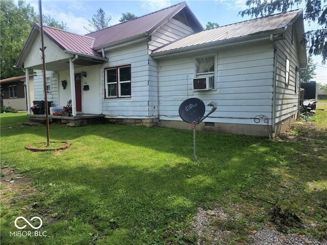 exterior space featuring cooling unit and a front yard