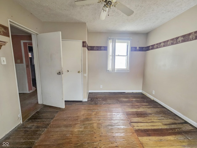 unfurnished bedroom featuring a closet, a textured ceiling, dark hardwood / wood-style floors, and ceiling fan