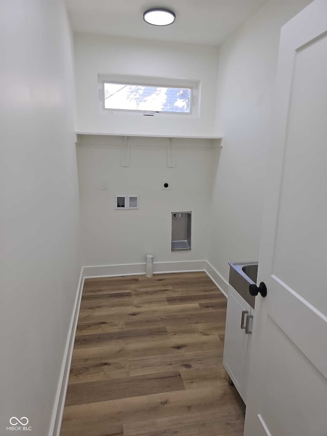 washroom with hookup for an electric dryer, dark hardwood / wood-style flooring, and washer hookup