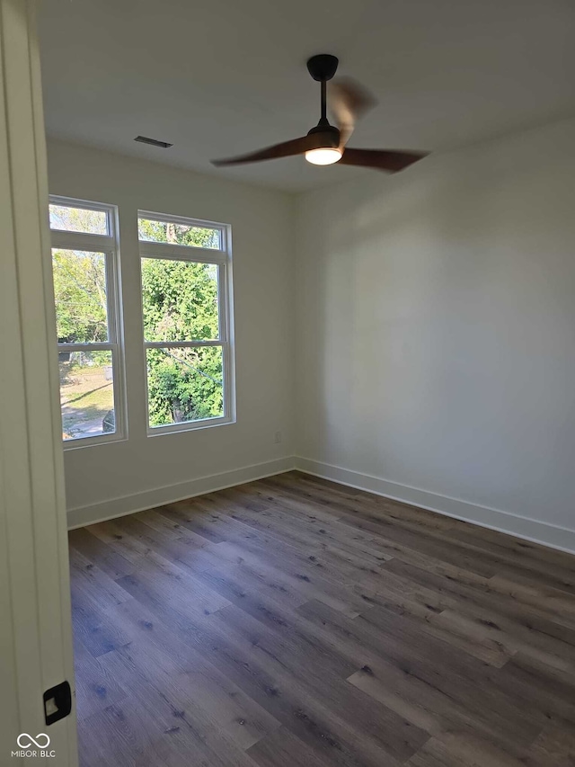 spare room with ceiling fan and dark hardwood / wood-style flooring