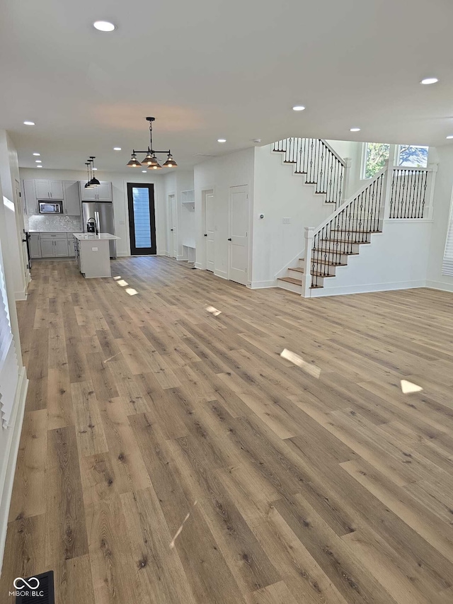 unfurnished living room featuring light hardwood / wood-style floors