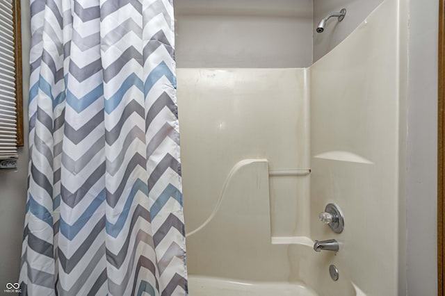 bathroom with shower / bath combination with curtain