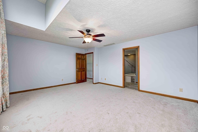 unfurnished bedroom with connected bathroom, ceiling fan, light carpet, and a textured ceiling