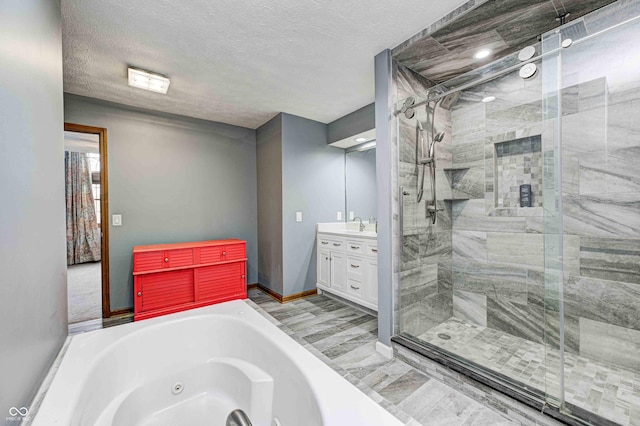 bathroom with plus walk in shower, a textured ceiling, and vanity