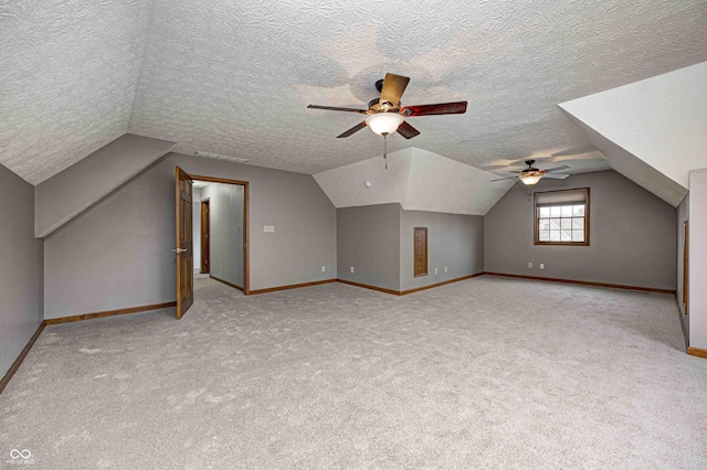 bonus room featuring a textured ceiling, ceiling fan, lofted ceiling, and light carpet