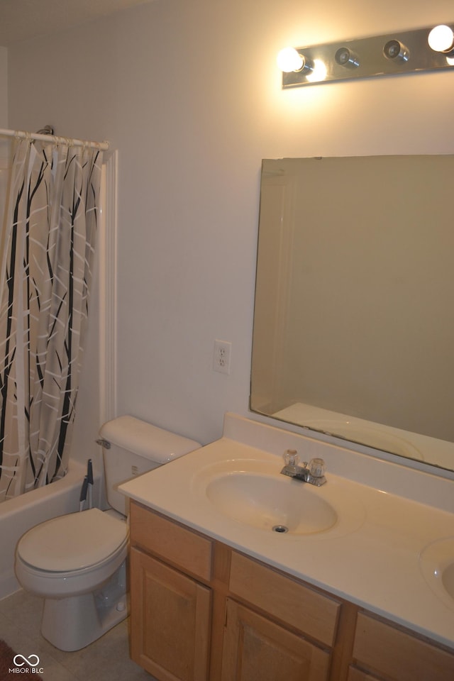 full bathroom with tile patterned floors, vanity, shower / tub combo, and toilet