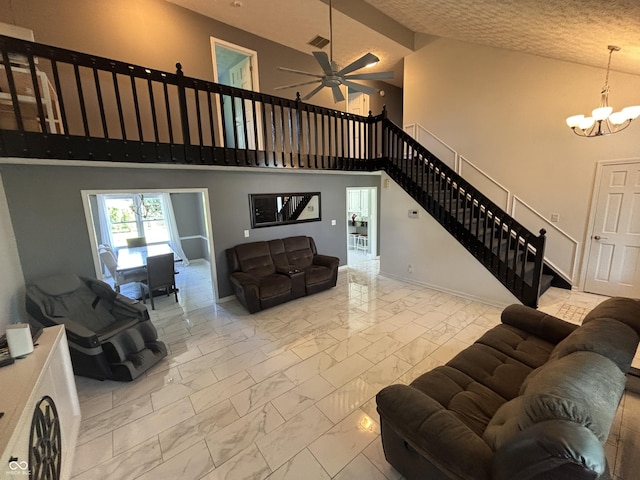 11720 Grenadier Ln, Indianapolis, IN 46229 - living room with marble look tiles, stairs, a high ceiling, a chandelier, and ceiling fan