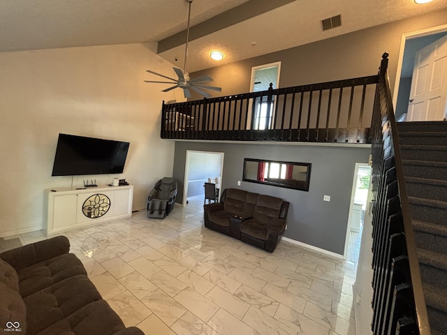11720 Grenadier Ln, Indianapolis, IN 46229 - living area with marble finish flooring, baseboards, a ceiling fan, stairs, and high vaulted ceiling