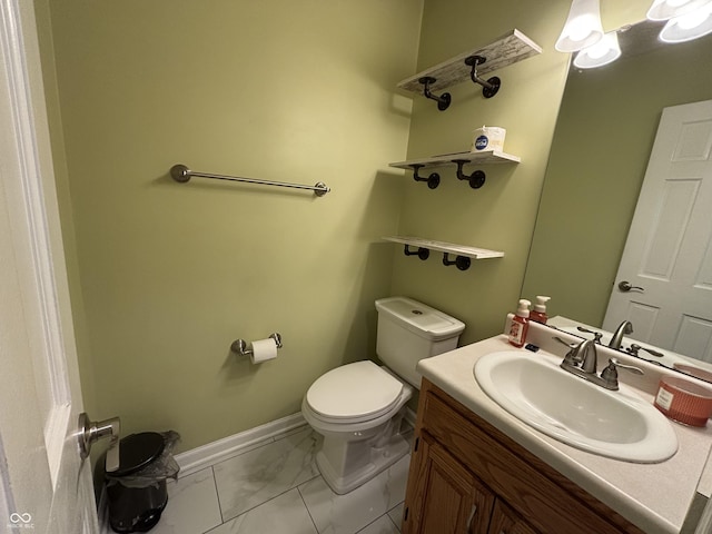11720 Grenadier Ln, Indianapolis, IN 46229 - bathroom featuring marble finish flooring, toilet, vanity, and baseboards