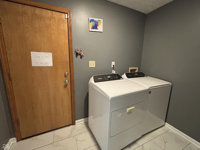 11720 Grenadier Ln, Indianapolis, IN 46229 - clothes washing area with washing machine and clothes dryer, light marble finish flooring, and baseboards
