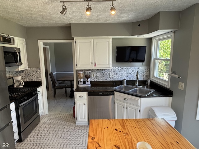 11720 Grenadier Ln, Indianapolis, IN 46229 - kitchen with appliances with stainless steel finishes, a sink, white cabinets, and tasteful backsplash