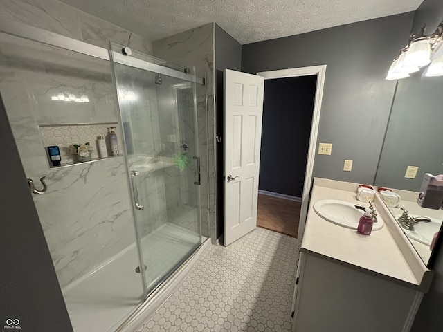 11720 Grenadier Ln, Indianapolis, IN 46229 - bathroom featuring a marble finish shower, vanity, and a textured ceiling
