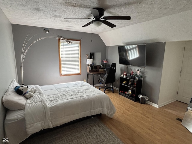 11720 Grenadier Ln, Indianapolis, IN 46229 - bedroom with wood finished floors, a textured ceiling, lofted ceiling, baseboards, and ceiling fan