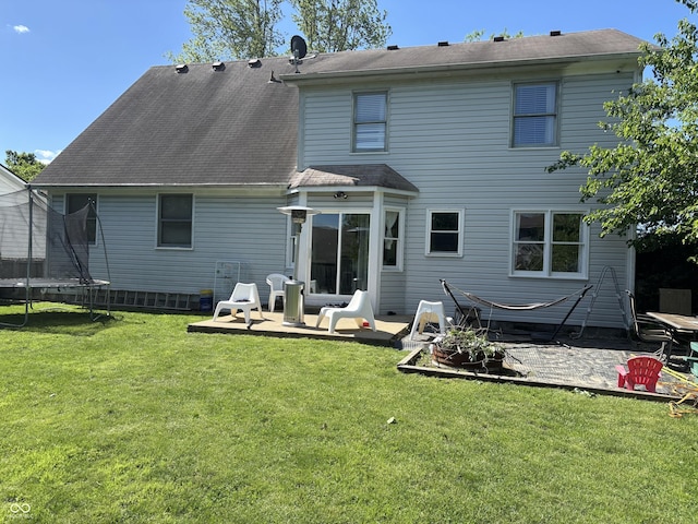 11720 Grenadier Ln, Indianapolis, IN 46229 - back of house with a trampoline, a patio, and a yard