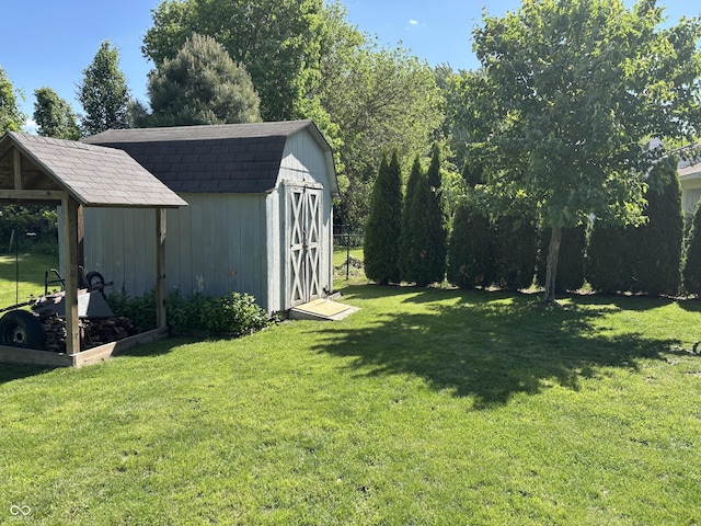 11720 Grenadier Ln, Indianapolis, IN 46229 - view of grassy yard with a storage unit and an outbuilding