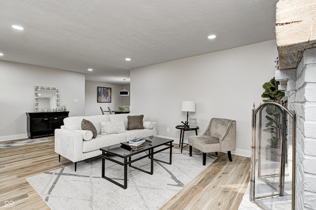 living room with a textured ceiling and hardwood / wood-style flooring