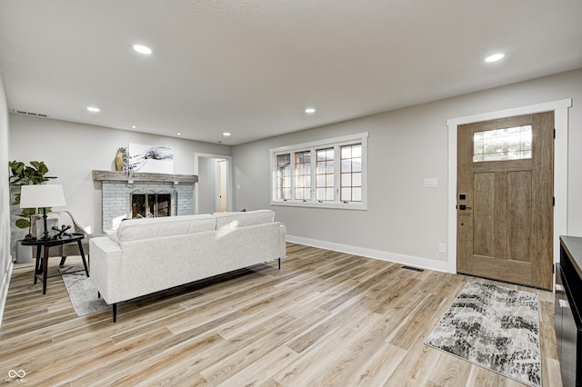 living room featuring a fireplace and light hardwood / wood-style flooring